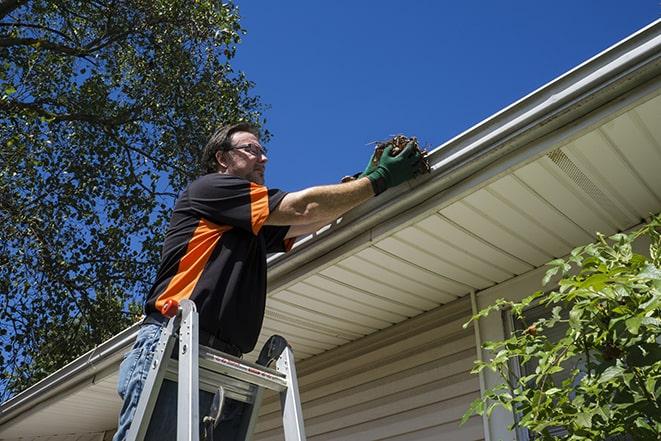 gutter repairman fixing a leaky drain in Eggertsville NY